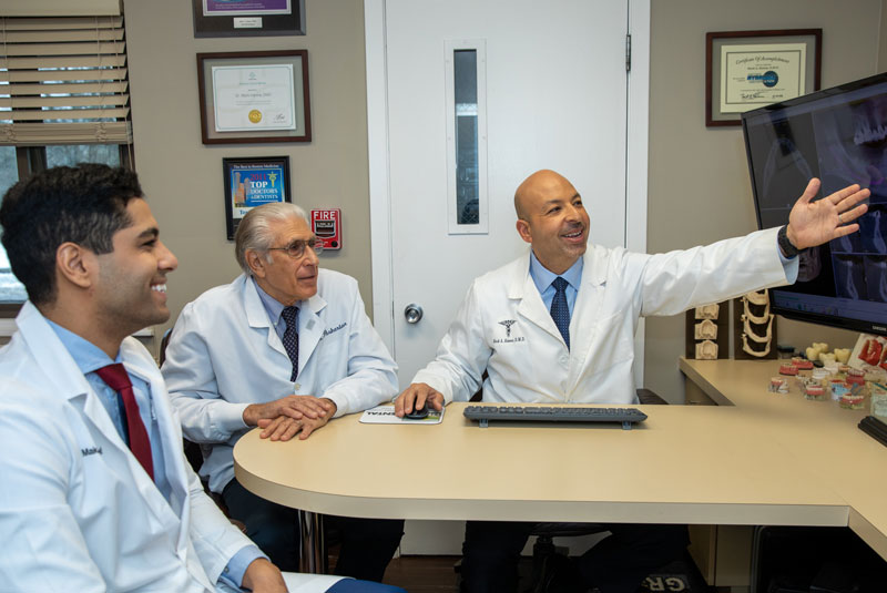 dr hanna and team discussing dental procedure